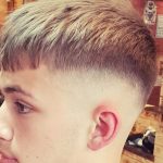 picture of a teenager with a skin fade and a haircut